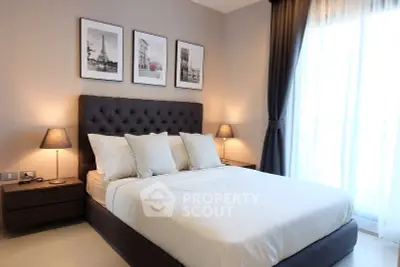 Elegant bedroom with stylish decor and natural light, featuring a comfortable bed and modern furnishings.