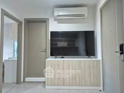 Modern living room with sleek TV setup and air conditioning unit