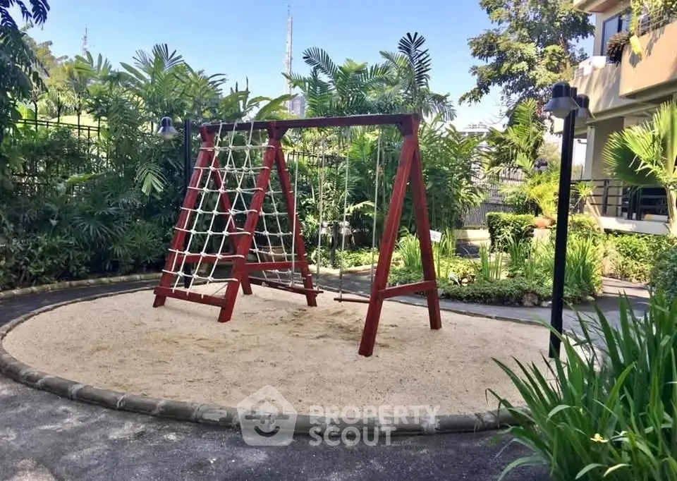 Charming garden playground with climbing frame in lush residential setting.