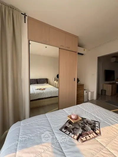 Modern bedroom with mirrored wardrobe and cozy decor