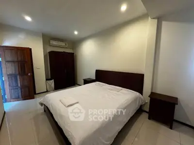 Spacious bedroom with modern furnishings and ample natural light