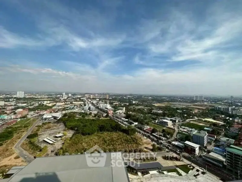 Stunning panoramic cityscape view from high-rise building, showcasing urban landscape and expansive sky.