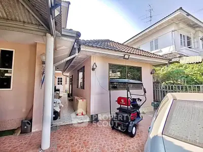 Charming suburban home with tiled patio and golf cart in driveway