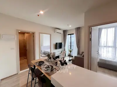 Modern open-plan living room with dining area and natural light