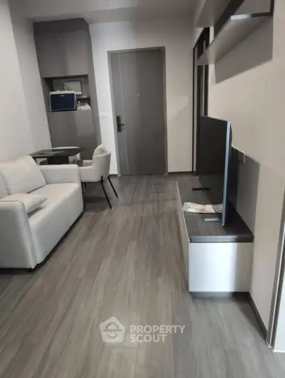 Modern living room with sleek furniture and stylish flooring in a contemporary apartment.