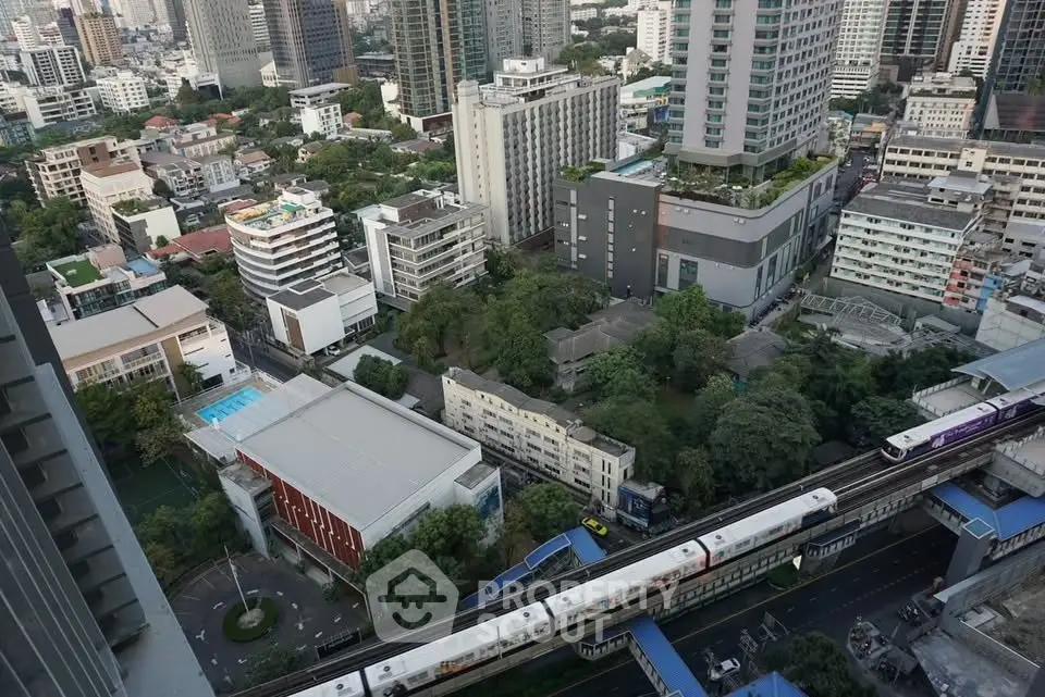 Stunning aerial view of urban skyline with modern high-rise buildings and lush greenery, perfect for city living.