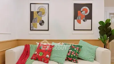 Stylish living room with modern art and festive decor, perfect for cozy gatherings.