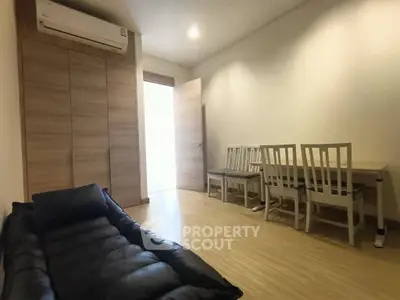 Modern living room with sleek furniture and wooden flooring