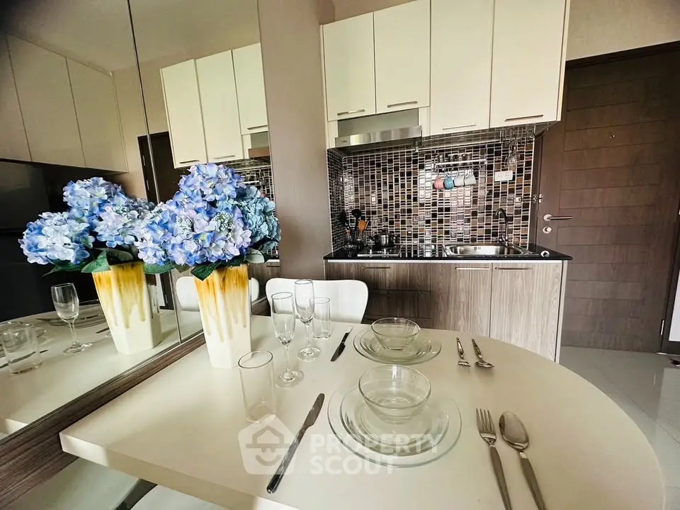 Modern kitchen with elegant dining setup and stylish backsplash
