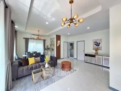 Spacious modern living room with stylish decor and ample natural light.