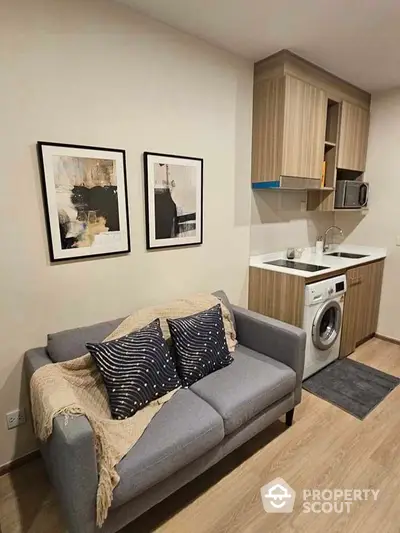 Modern compact living room with integrated kitchen and washing machine