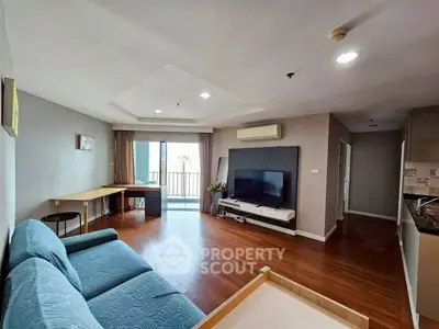 Spacious living room with modern decor and balcony access
