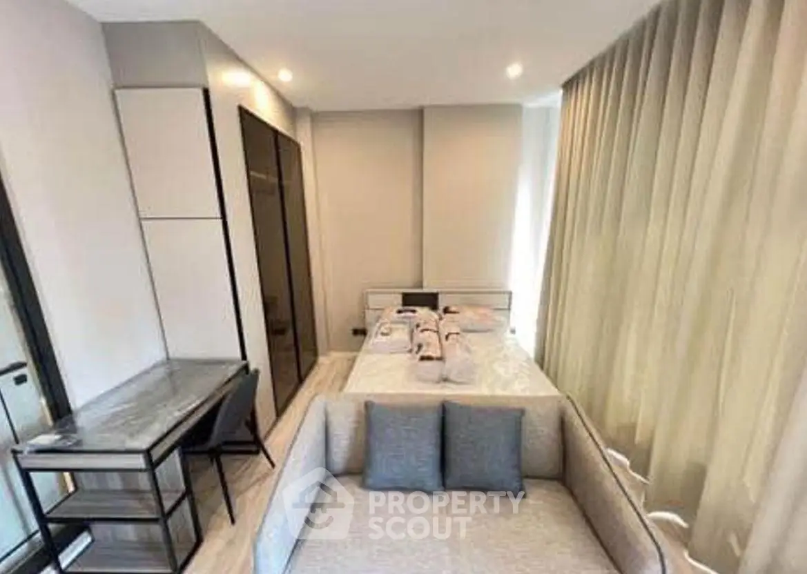 Modern studio apartment with cozy living area and stylish decor.
