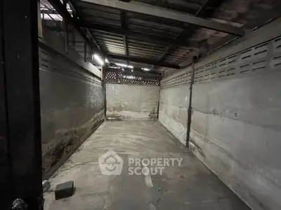Spacious industrial-style storage unit with concrete walls and metal roof, ideal for secure storage needs.
