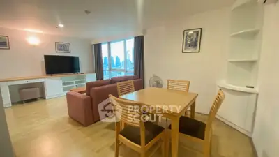 Spacious living room with dining area and city view, featuring modern furniture and large windows.