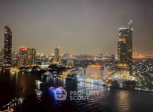 Stunning city skyline view with illuminated skyscrapers and river at night.