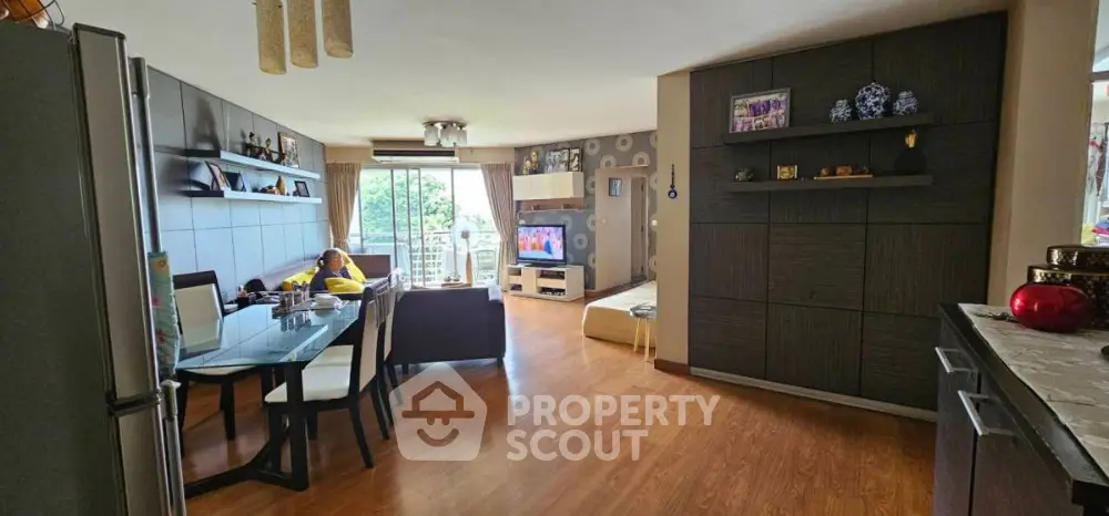 Spacious living room with modern decor and large windows offering natural light
