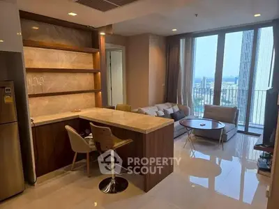 Modern open-layout living room with kitchen and city view balcony