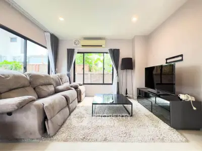 Spacious living room with plush sofas and modern decor, perfect for relaxation and entertainment.