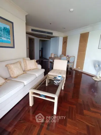 Spacious living room with elegant wooden flooring and cozy seating area