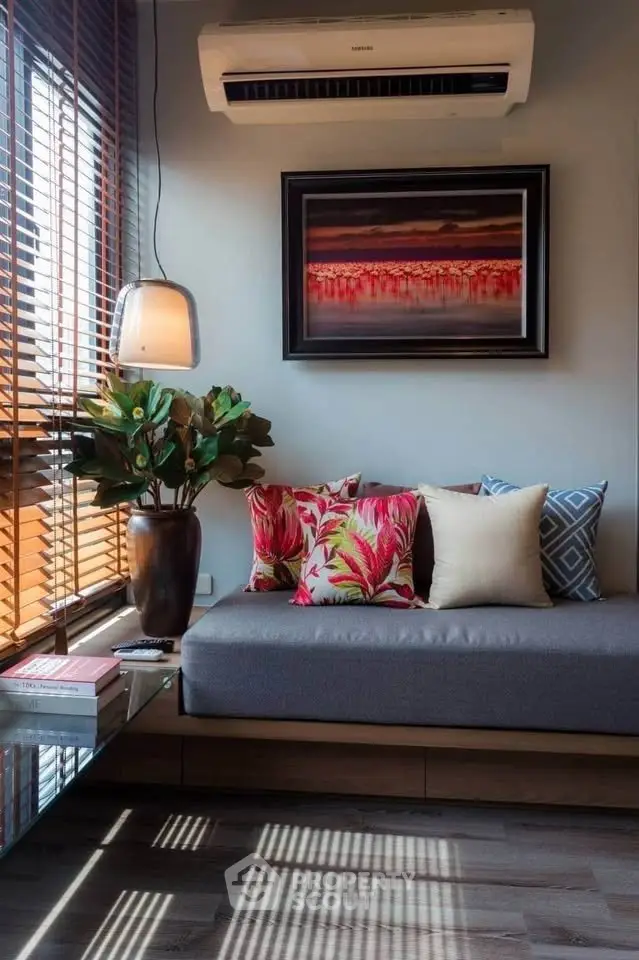 Chic living room with modern decor and vibrant cushions under soft lighting.