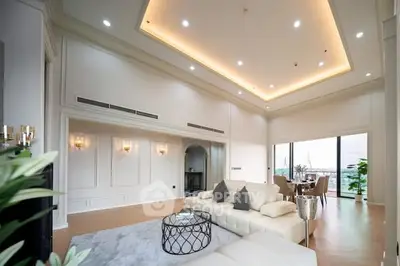 Luxurious living room with high ceilings and elegant decor, featuring a spacious layout and stunning views.