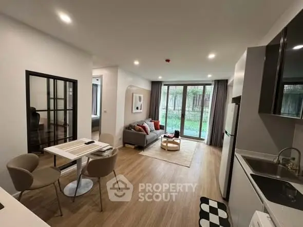 Modern open-plan living room with stylish decor and garden view.