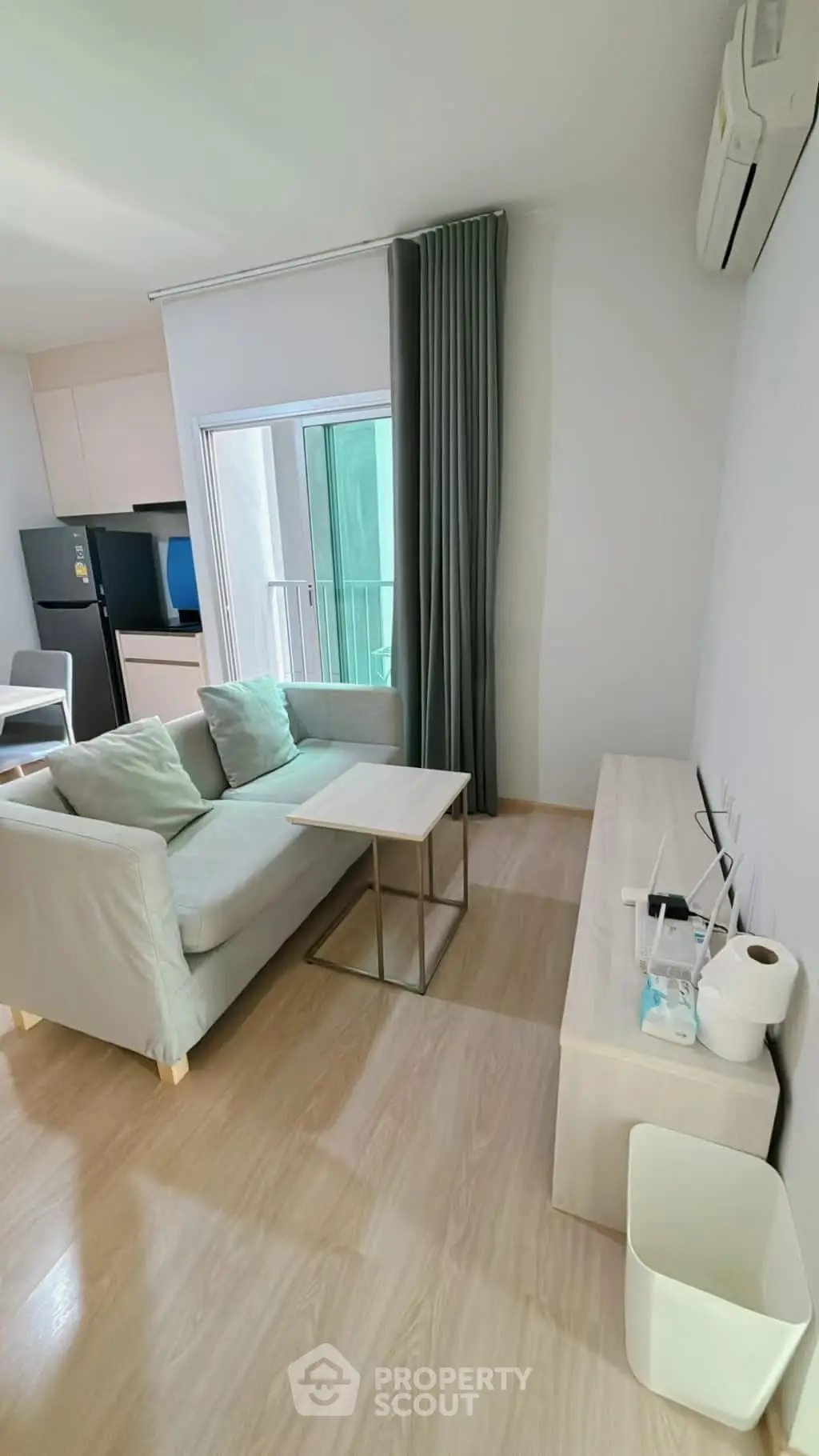 Modern living room with sleek furniture and natural light, featuring a cozy sofa and stylish decor.