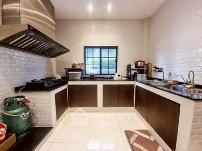 Modern kitchen with sleek cabinets and gas stove, perfect for culinary enthusiasts.