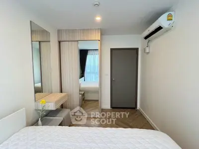 Modern bedroom with mirrored wardrobe and air conditioning in a stylish apartment.