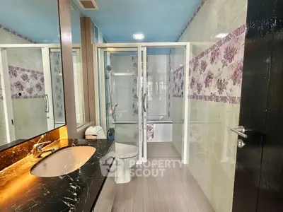 Luxurious bathroom with floral accents and modern fixtures