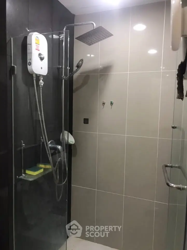 Modern bathroom with glass shower enclosure and rain shower head