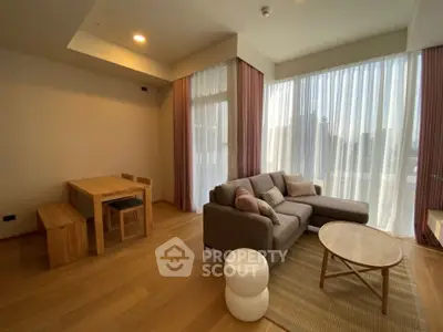 Spacious living room with modern furniture and large windows offering natural light.