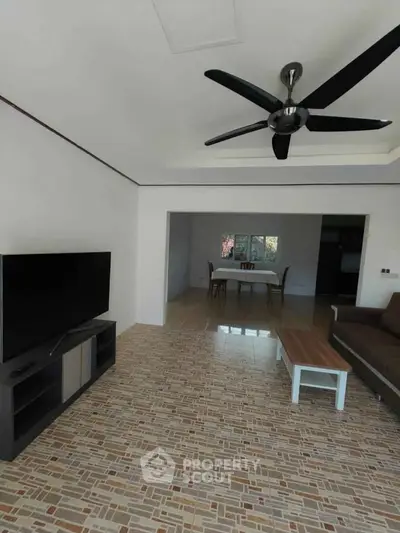 Spacious living room with modern ceiling fan and tiled flooring
