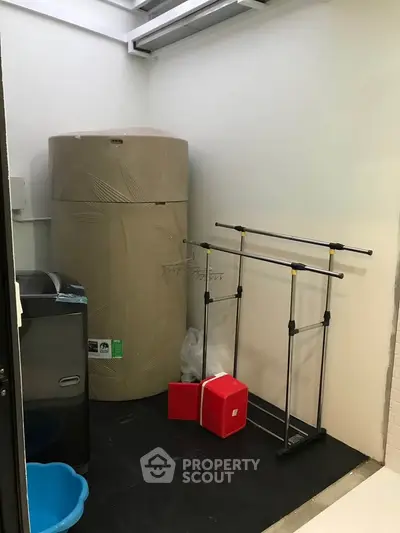 Utility room with water tank and laundry equipment in modern home