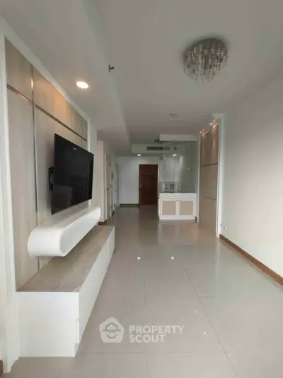 Spacious modern living room with sleek TV setup and elegant lighting