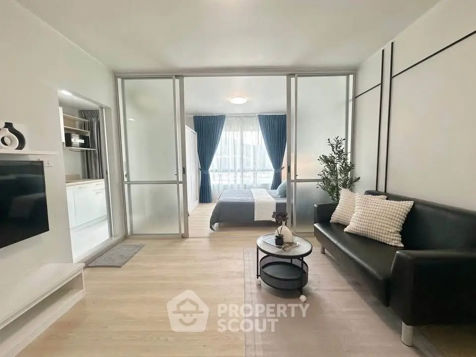 Modern open-plan living room with sleek decor and natural light