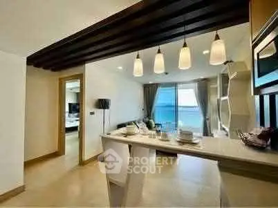 Modern open-layout living room with ocean view and stylish kitchen bar