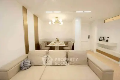 Modern living room with elegant dining area and cozy beige sofa