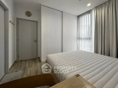 Modern minimalist bedroom with sleek design and natural light