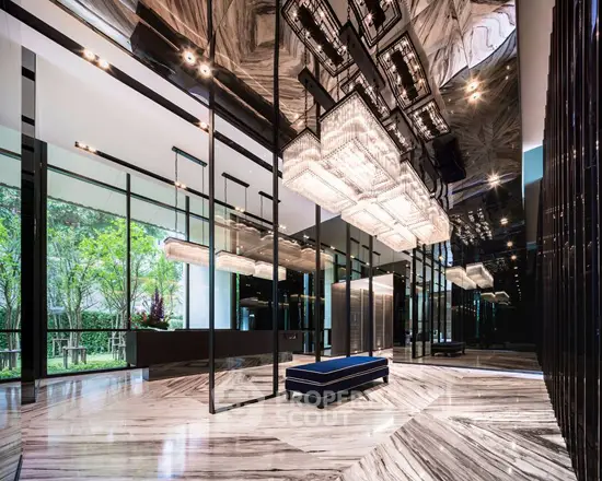 Luxurious modern building entrance with elegant lighting and marble flooring.