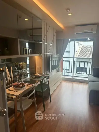 Modern living room with sleek design, large windows, and stylish dining area in a cozy apartment.