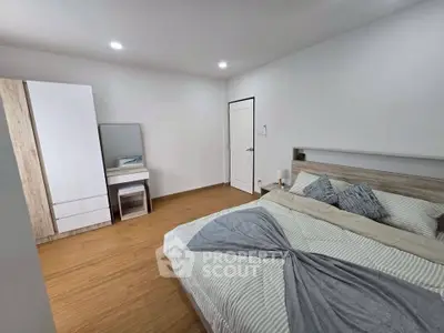 Modern bedroom with stylish decor and wooden flooring