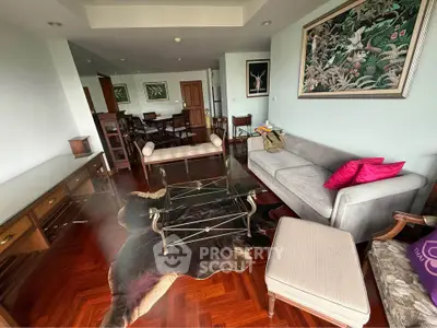 Spacious living room with elegant decor and hardwood floors in a modern apartment.