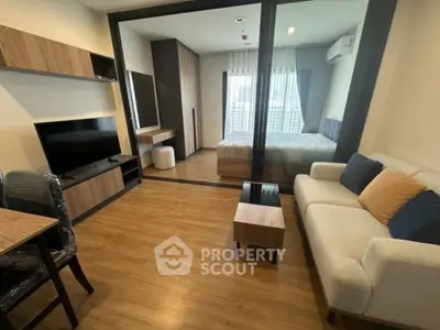 Modern studio apartment with open layout, featuring cozy living area and stylish bedroom.