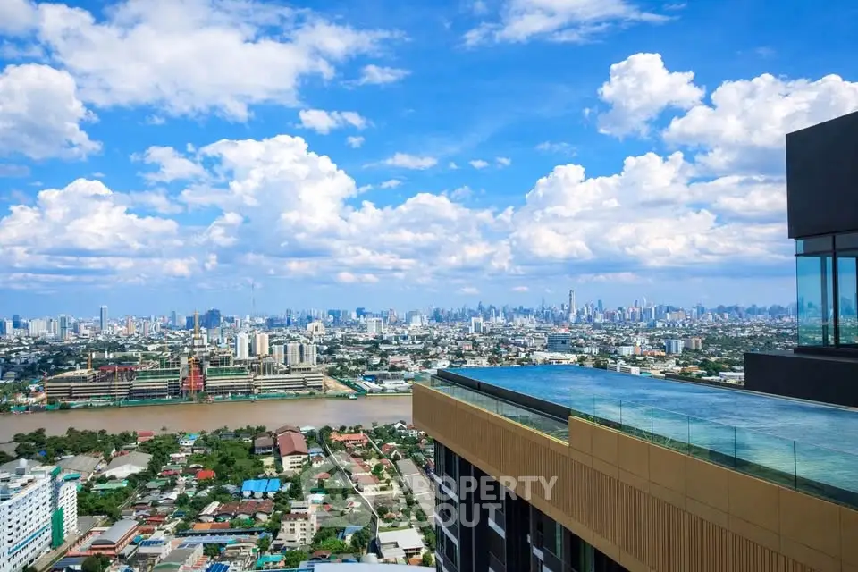 Stunning cityscape view from a modern rooftop with infinity pool overlooking a vibrant urban skyline.