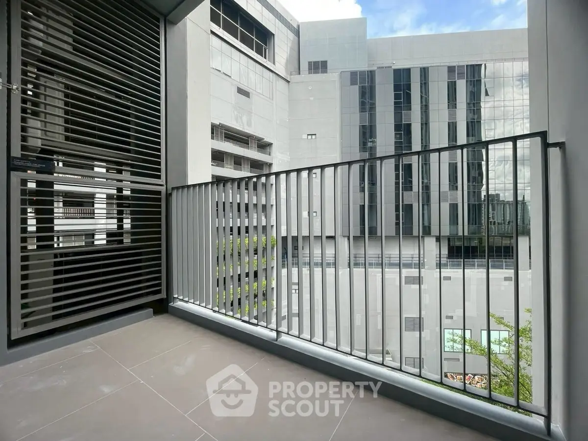 Modern apartment balcony with sleek railing and urban view