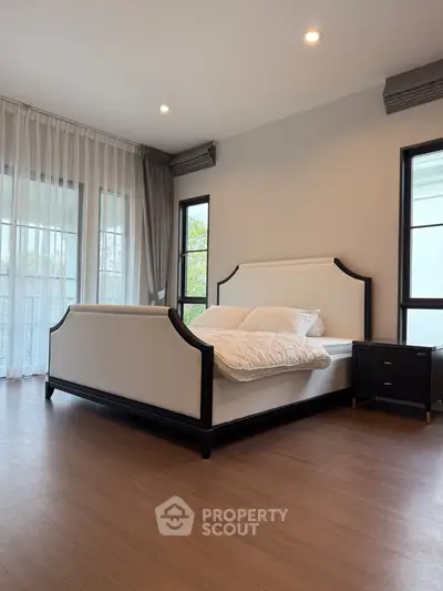 Elegant bedroom with modern design and large windows for natural light