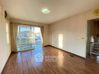 Spacious empty living room with large windows and wooden flooring