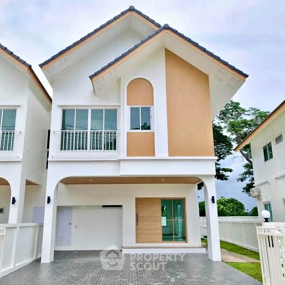 Modern two-story house with unique architectural design and spacious driveway.